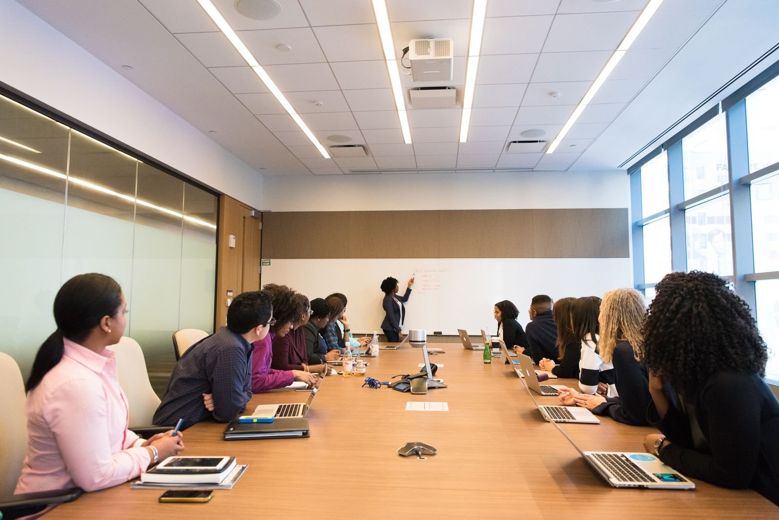 Participants work together around a meeting table.